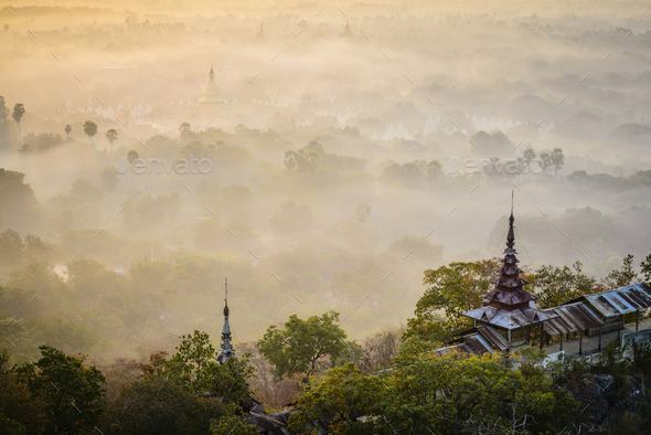 The view over the plain of temples, stupas rising from the mist, lakes and woodland. - Stock Photo - Images
