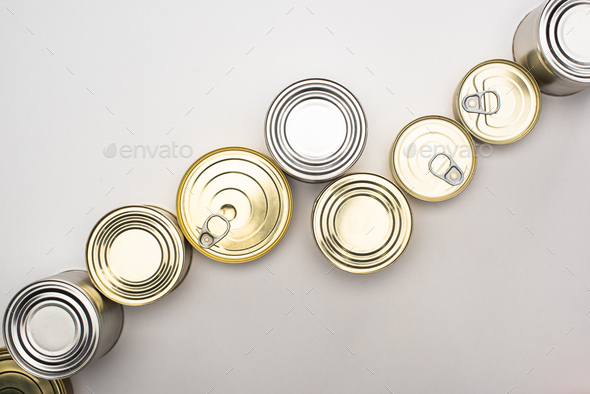 top view of cans with canned food on white background, food donation concept