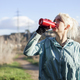 Young woman athlete takes a break, drinking water, out on a run on a hot day - PhotoDune Item for Sale
