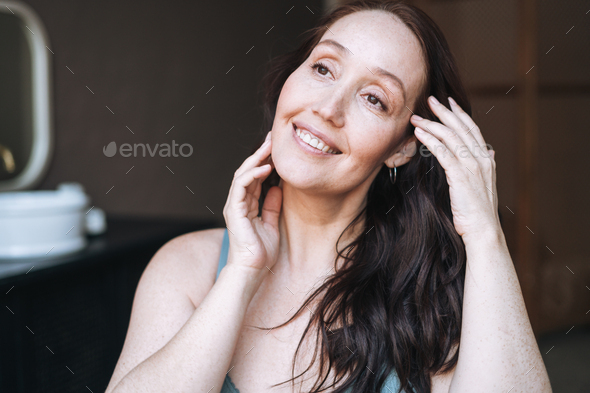 Close up portrait of smiling adult brunette woman in underwear in bathroom at home - Stock Photo - Images