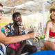 Three multiracial friends, two Caucasian women and an African man, having fun toast with mojito cock - PhotoDune Item for Sale