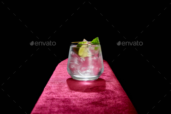Old fashioned glass with fresh cold mojito, mint and lime slice isolated on black - Stock Photo - Images