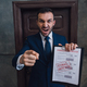 Angry collector with documents with foreclosure lettering pointing with finger and shouting in room - PhotoDune Item for Sale