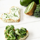 selective focus of heart shaped canape with creamy cheese, broccoli, microgreen near green fruits - PhotoDune Item for Sale
