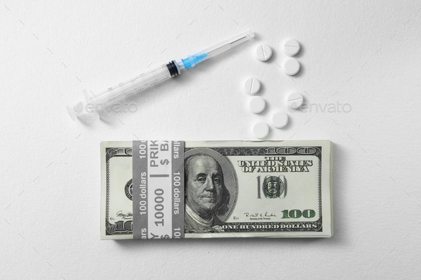 money, dollars banknote, pills and syringe on white background, medical expense concept. Concept of