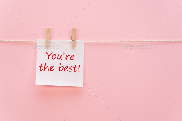 White sticker on a rope with a clothespin with an inscription - Stock Photo - Images