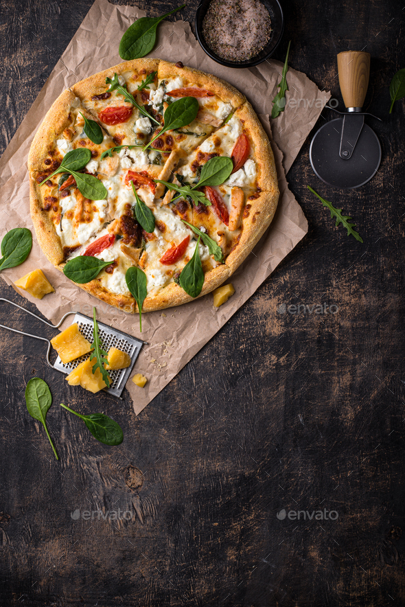 Italian pizza with feta cheese, tomato and basil - Stock Photo - Images
