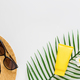 Top view of suncream, straw hat, palm leaf, sunglasses. spf cream on white background with copy - PhotoDune Item for Sale