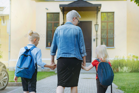 mother accompanies children to school holding hands. - Stock Photo - Images