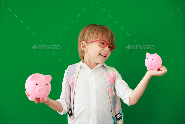 Happy child student against green chalkboard - Stock Photo - Images