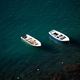 Small fishing boats in turquoise, clear water, Procida, Italy. - PhotoDune Item for Sale