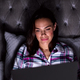 Smiling Woman At Home Sitting In Bed Using Laptop At Night - PhotoDune Item for Sale