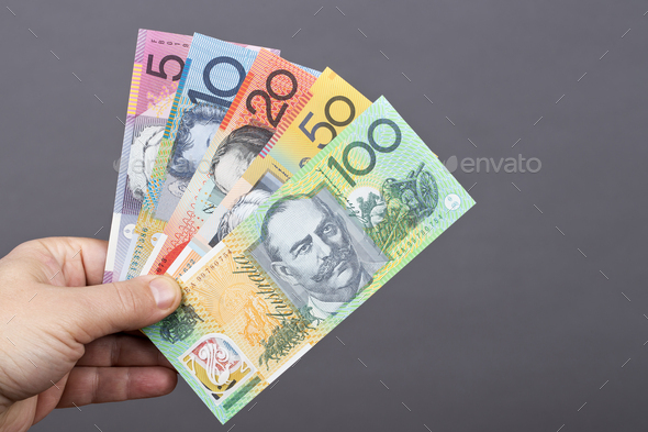 Australian money in the hand on a gray background - Stock Photo - Images