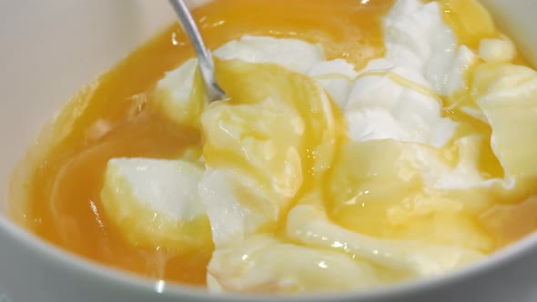Mixing of White Cream and Eggs Inside the Bowl
