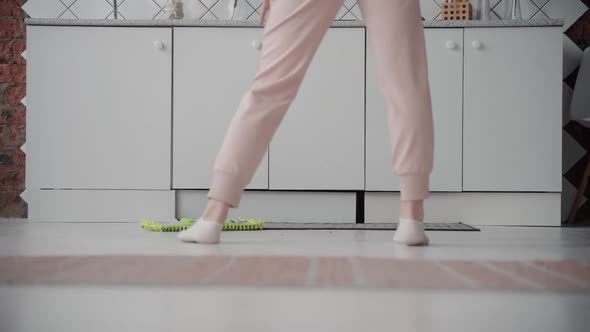 Close Up Happy Woman Cleaning Floor with Mop, Indoors. Housekeeping Concept. Energetic Girl
