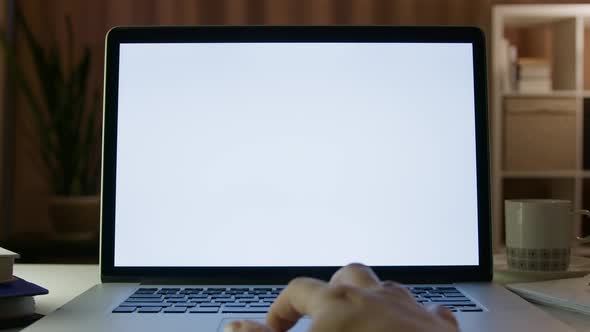 Close Up on Hands of Specialist Working on Laptop Computer with White Screen Mock Up Display at Home alt