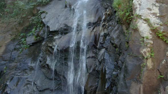 Water Flowing Down To Rocky Cliff Of Cascada de Yelapa In Jalisco, Mexico. - aerial, closeup alt