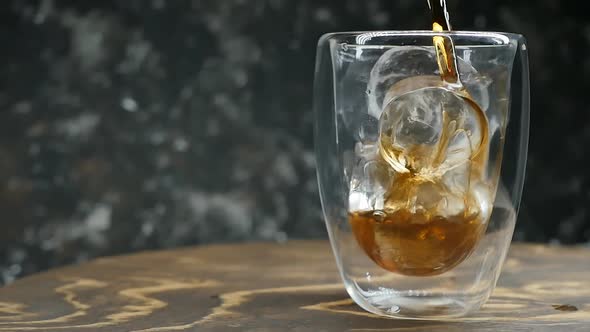 Pour Cola Into a Glass Beaker with Ice Cubes