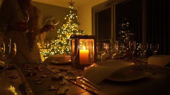 Woman Decorating Dinner Table at Christmas