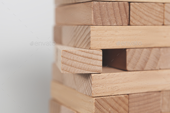Selective focus shot of a wooden block tower isolated on a white background