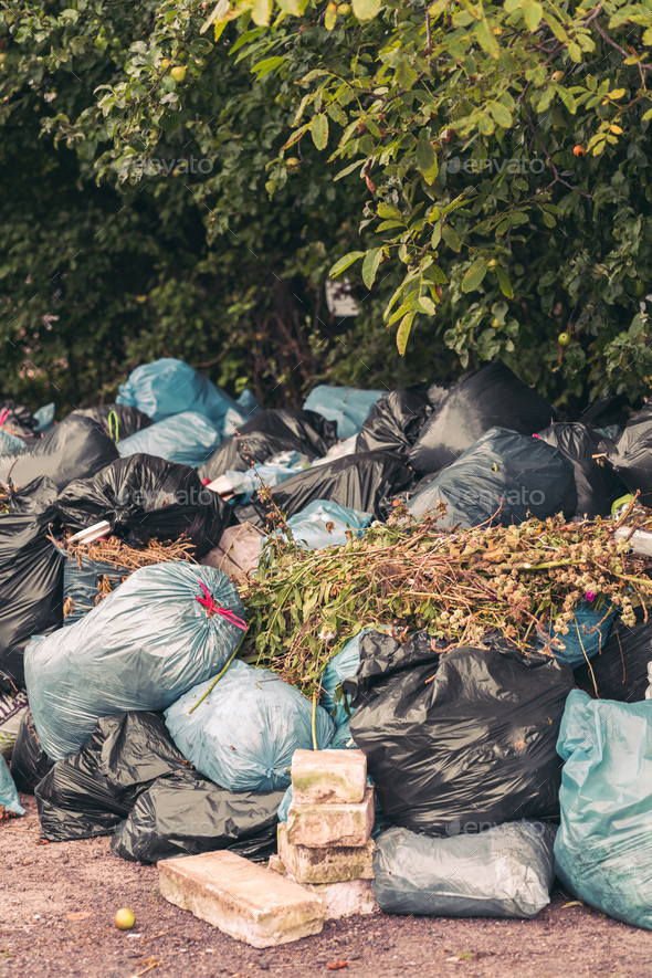 Vertical shot of a pile of trash bags - pollution concept - Stock Photo - Images