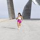 Athlete woman in sportswear running strong through the city. front view - PhotoDune Item for Sale