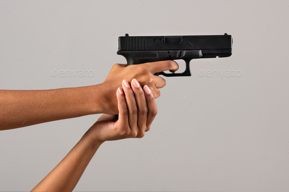 Female black hands with gun - Stock Photo - Images