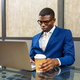 Black young businessman working on laptop - PhotoDune Item for Sale