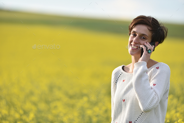 Woman talking on her smart phone - Stock Photo - Images