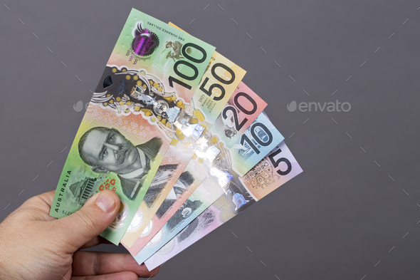 Australian money in the hand on a gray background - Stock Photo - Images