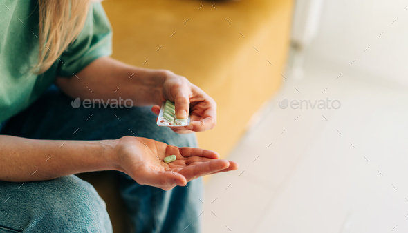 Close-up of a woman holding pills. Copy space - Stock Photo - Images