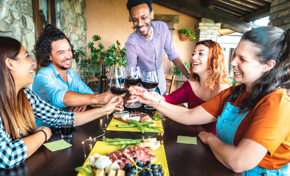 Happy friends having fun drinking at farm house garden patio - Stock Photo - Images