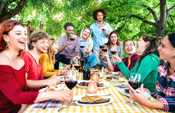 Happy people having fun toasting wine out side farm house - Stock Photo - Images