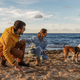 Loving couple is playing with their dog at the beach  - PhotoDune Item for Sale