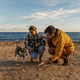 Loving couple is playing with their dog at the beach  - PhotoDune Item for Sale
