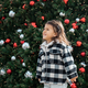 Lifestyle portrait of toddler girl smiling near Christmas tree  - PhotoDune Item for Sale