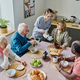 Caregiver caring about senior people during lunch - PhotoDune Item for Sale