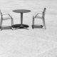 Black and white photo of two chairs at an empty table, space for text. - PhotoDune Item for Sale