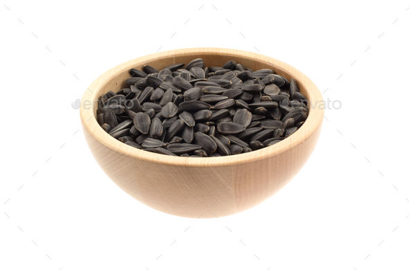 sunflower seeds in a wood bowl - Stock Photo - Images