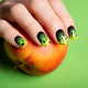 Female neat hand with short natural nails painted with green nail polish holding apple.  - PhotoDune Item for Sale