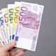 European money in the hand on a gray background - PhotoDune Item for Sale