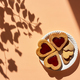 Heart shaped homemade cookies with strawberry jam on patel peach background with leaf shadows. - PhotoDune Item for Sale