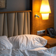Hotel room with a comfortable bed, clock and modern decor - PhotoDune Item for Sale