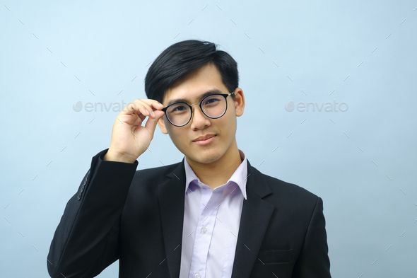 Portrait of businessman standing and looking at camera. - Stock Photo - Images