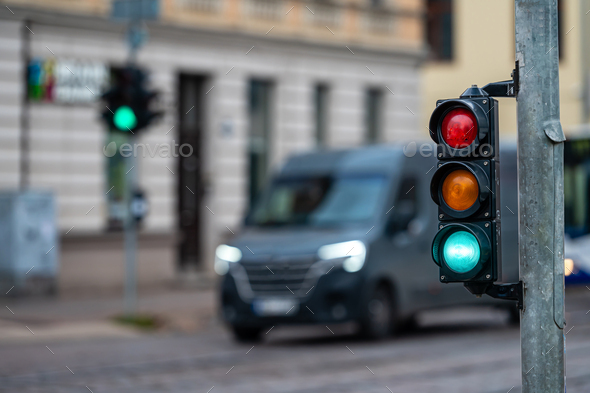 traffic light on the street junction with beautiful bokeh, city with cars in the background - Stock Photo - Images