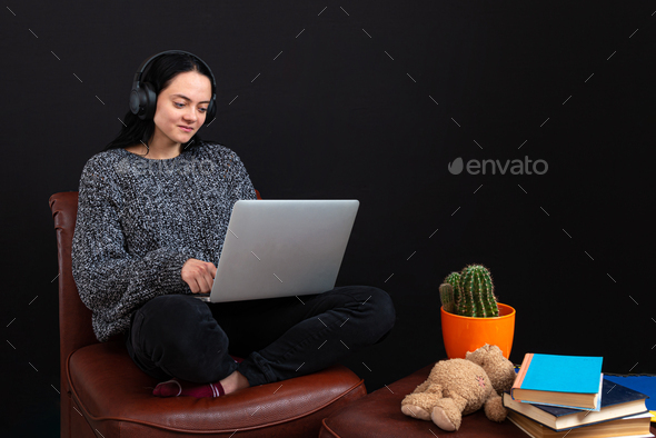 focused young freelance woman sitting with laptop and headphones, have business meeting, video call - Stock Photo - Images