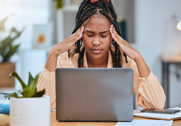 Black woman, headache and depression with laptop while tired in home office  of studying or working. Stock Photo by YuriArcursPeopleimages