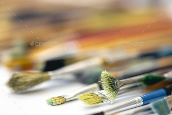 Many brushes for painting on a white background, top view. Stock Photo by  puhimec