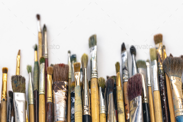 Many brushes for painting on a white background, top view. Stock Photo by  puhimec