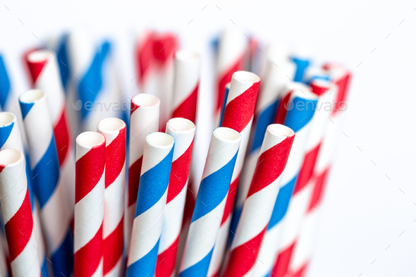 Multi-colored paper straws for drinks close-up on a white background. - Stock Photo - Images